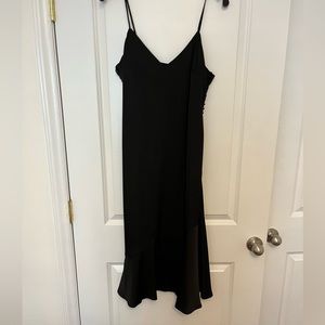 Black slip dress with buttons on one side. Zipper closure. Adjustable straps.